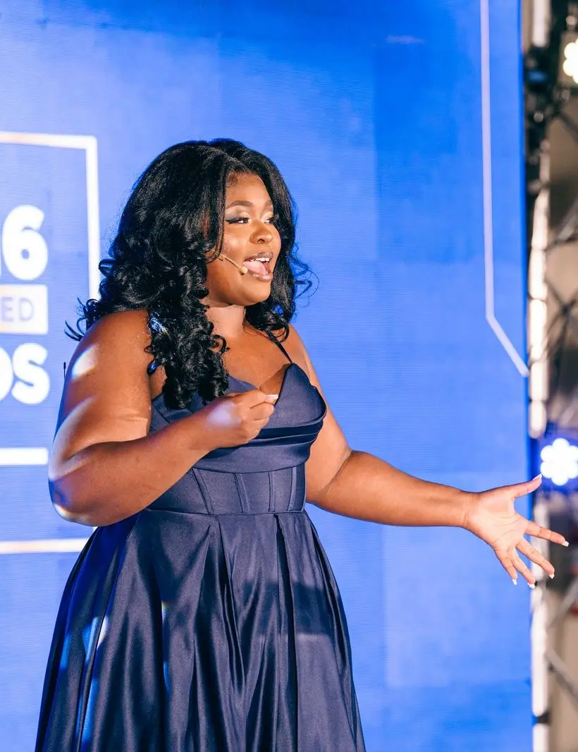 Elma Akob speaking on stage